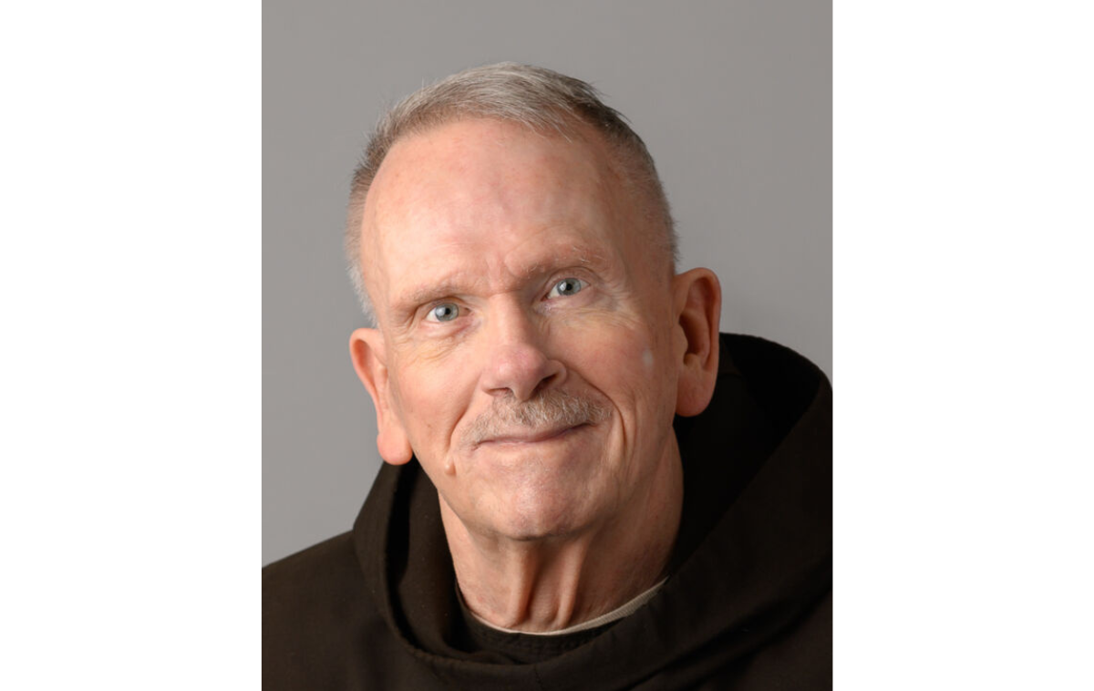 A smiling man wearing a friar habit.