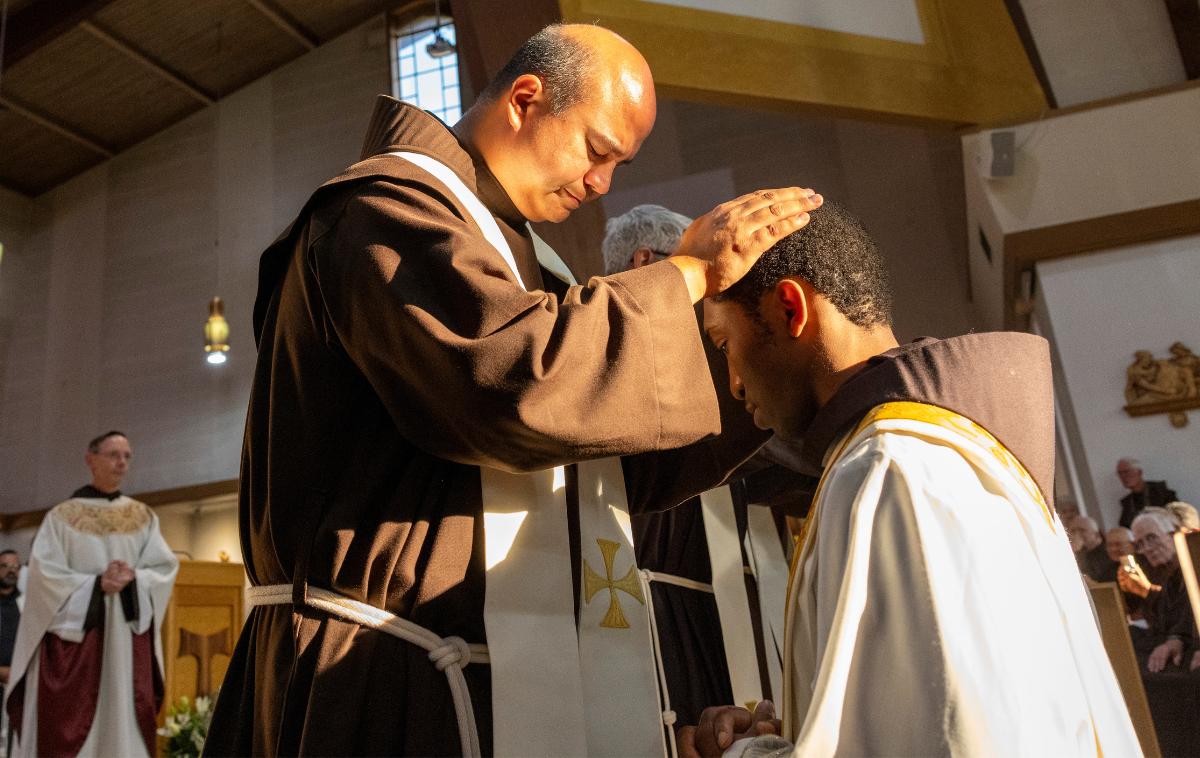 Provincial Councilor Br. Roger Lopez, OFM, lays hands on Br. Raphael Nnabuikem Ozoude III, OFM, during an ordination Mass at Holy Family Catholic Church in Albuquerque, New Mexico. “With the ... Holy Spirit’s power passed on through the laying of hands, Matthew, Rafael and Noé will be set aside to preach, lead and sanctify the people of God,” said Bishop John Stowe, OFM, Conv., who presided the ceremony. (Photo courtesy of Br. Octavio Duran, OFM) 