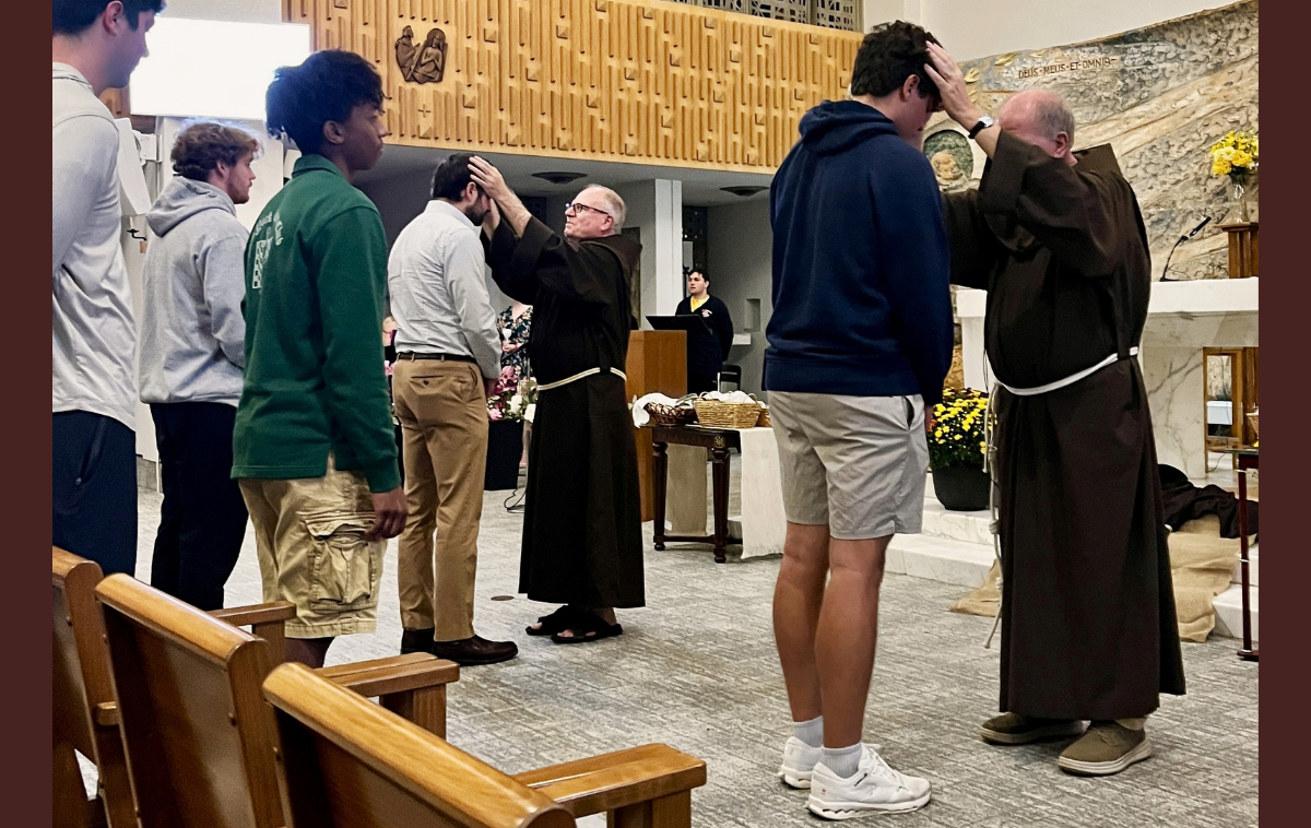 Brothers Larry Ford, OFM, left, and Kevin Kriso, OFM, blessed students as part of Francis Week at St. Bonaventure University&rsquo;s campus chapel. (Photo by Br. Jud Weiksnar, OFM)