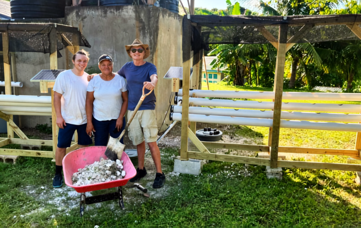 Christian, who developed a simple way to build hydroponic farms for an Eagle Scout project, is pictured in Jamaica with a local resident and Br. Mike. (photo courtesy of Levo International)