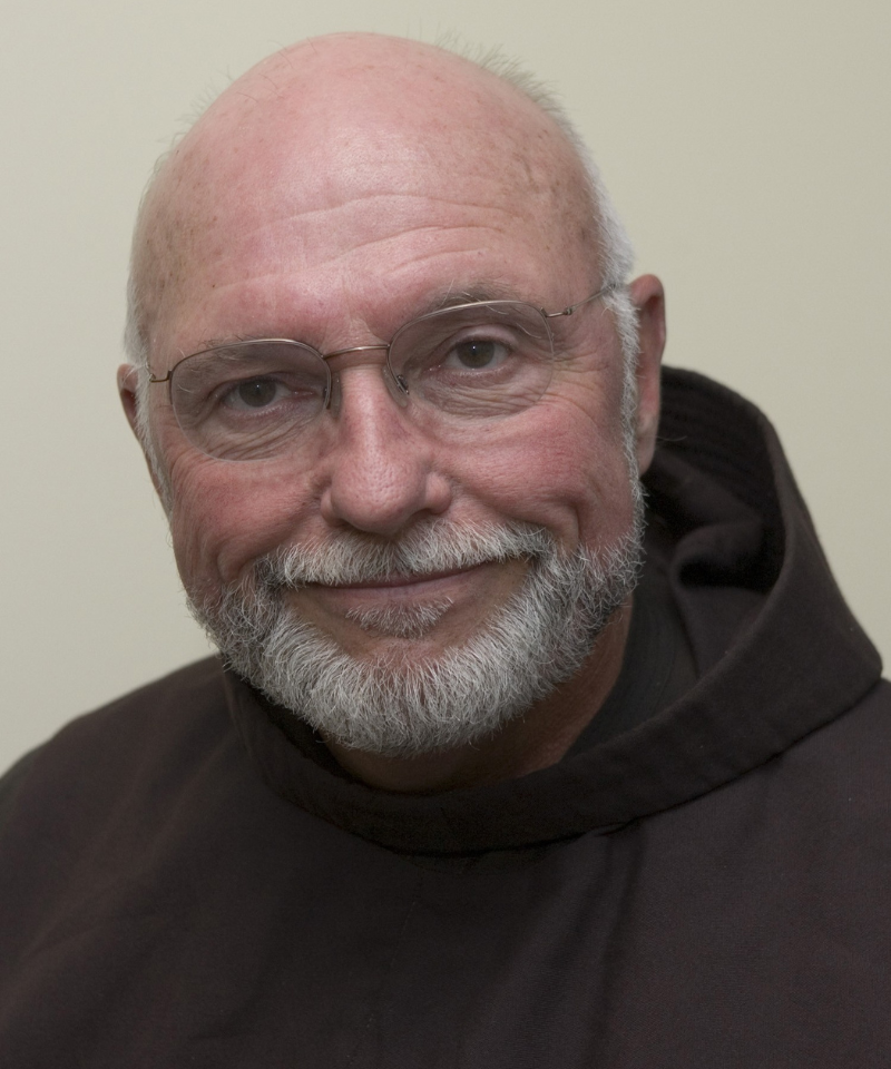A man wearing glasses and a friar habit