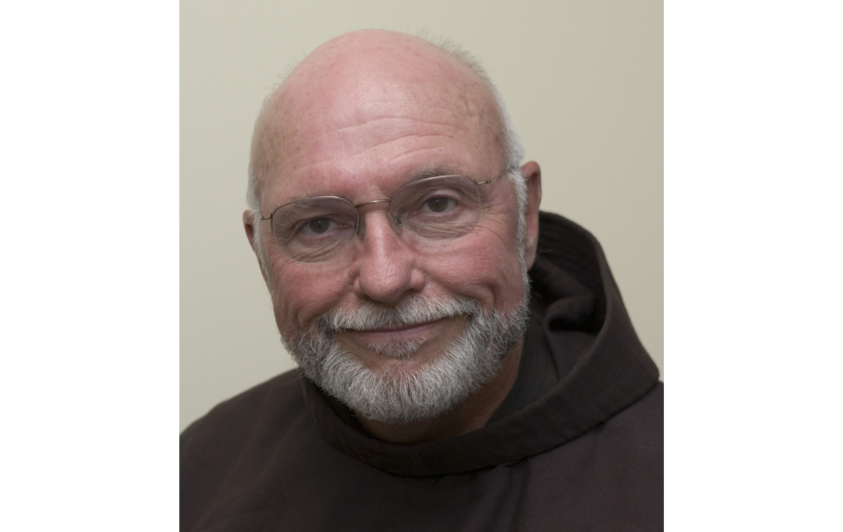 A bearded man wearing eyeglasses and a Franciscan friar habit