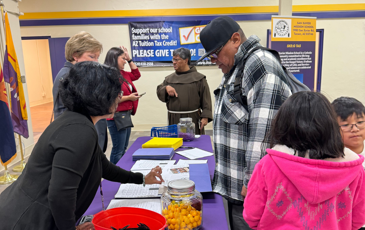 Staff welcome prospective students and their families to the school