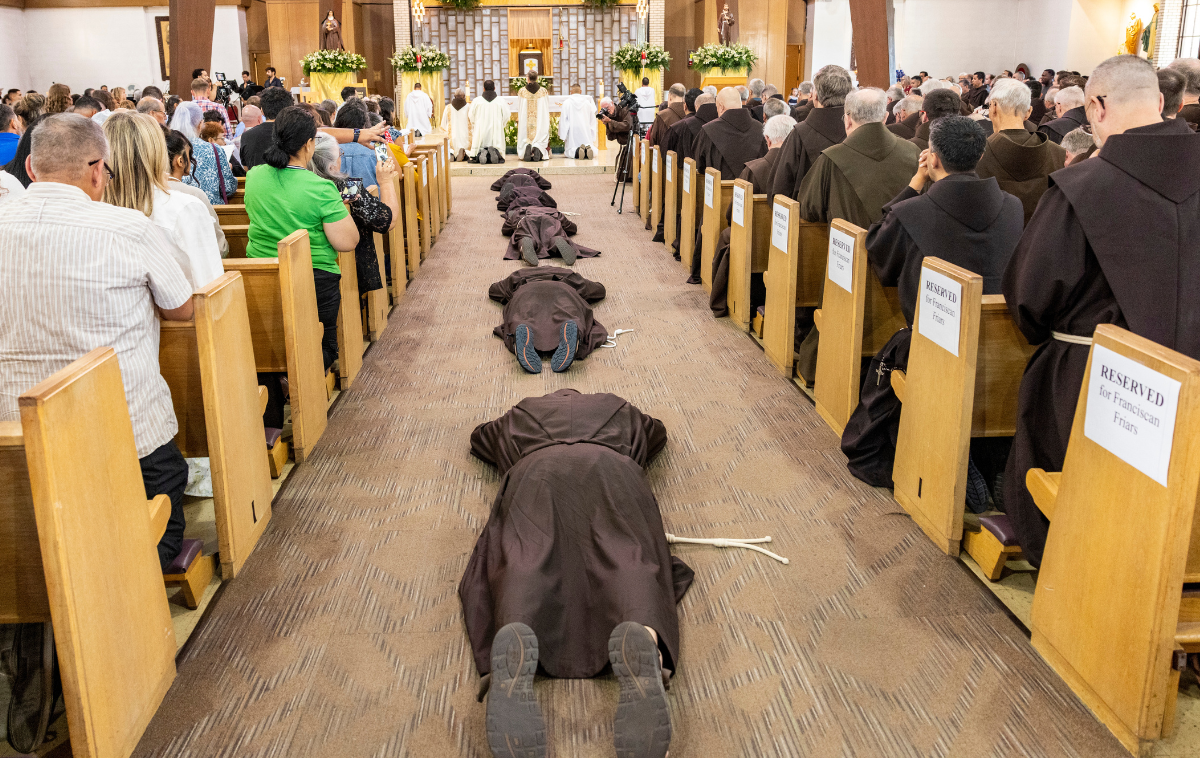 The candidates for solemn vows lie prostrate in the nave at Holy Family Catholic Church in Albuquerque, New Mexico. “The Holy Spirit will guide me and help me to discern the signs of the times,” said Br. Edgar Alberto, OFM. (Photo courtesy of Br. Octavio Duran, OFM)