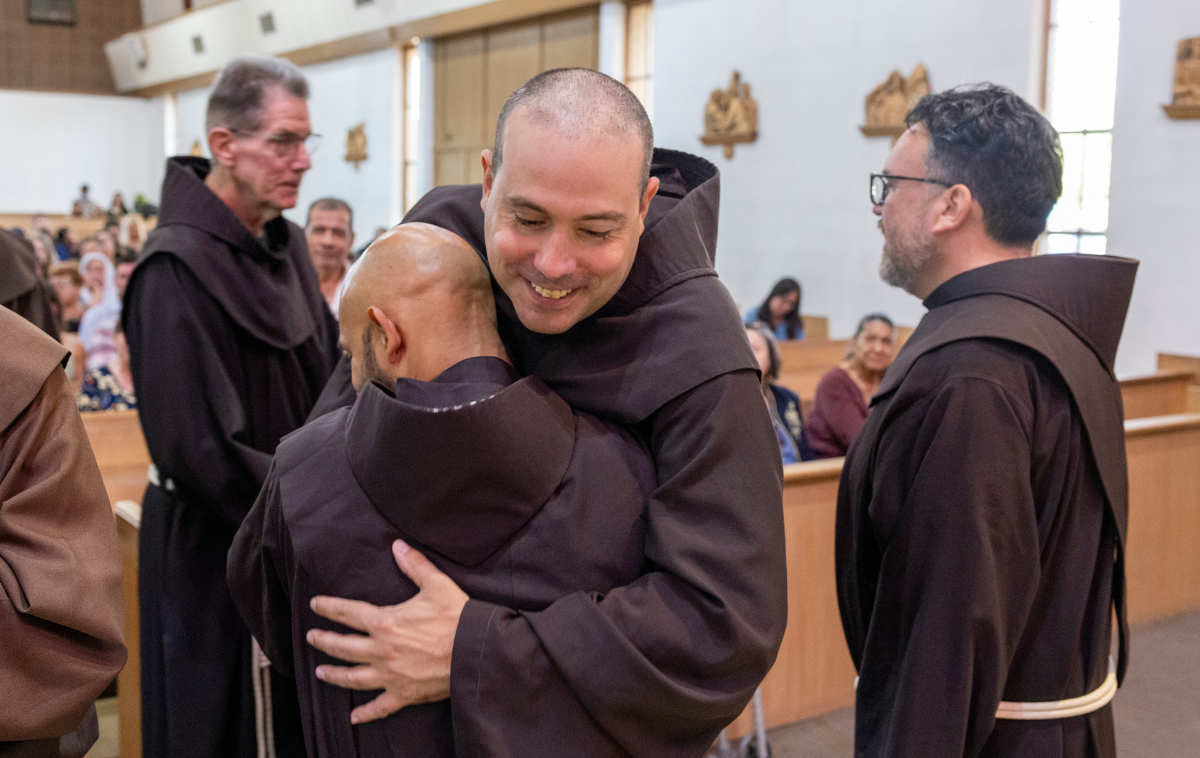 Br. James LaGrutta, OFM, greets solemn profession candidate Br. Edgar Alberto, OFM. The smiles and embrace of more than 100 friars on hand in support of their brothers were present throughout the day. (Photo courtesy of Br. Octavio Duran, OFM)