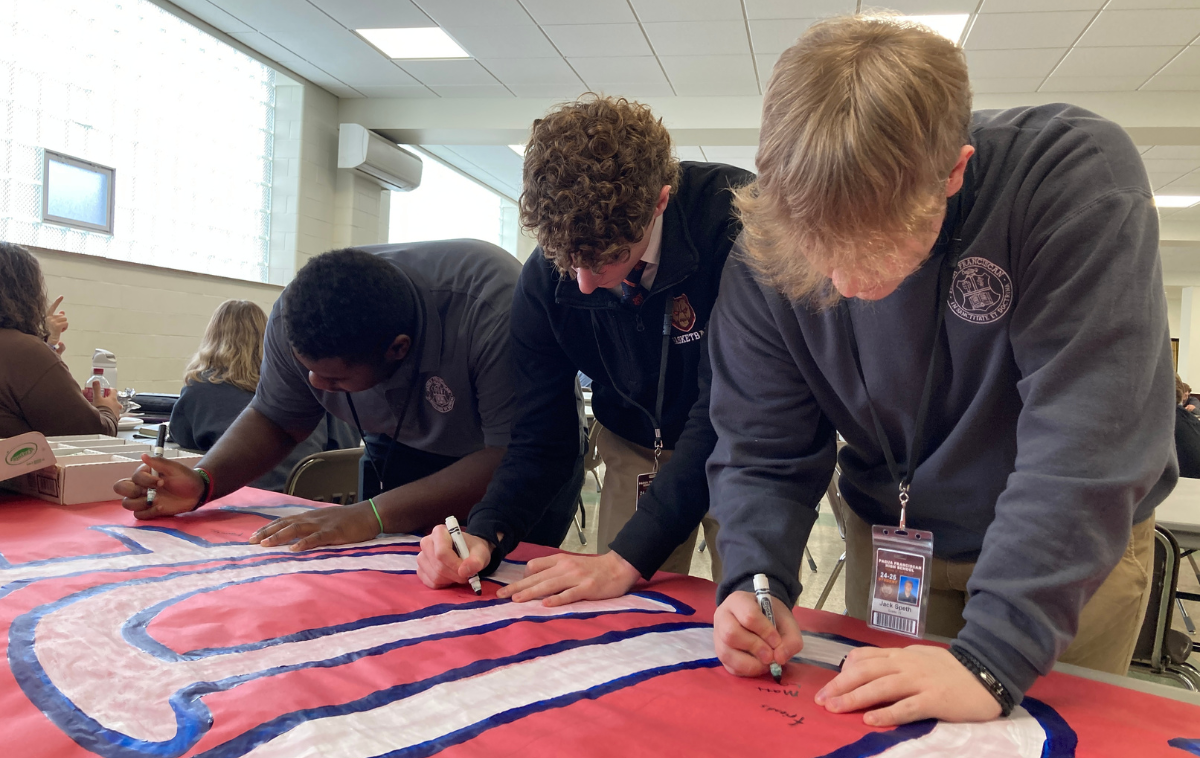 Students pray together during Mass.