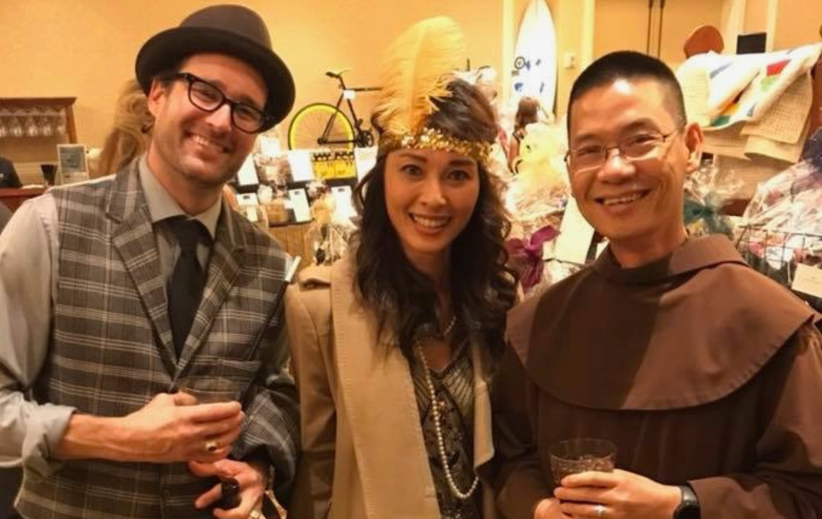 Br. Vincent Nguyen, OFM, speaks with parishioners at the Sts. Simon and Jude Parish auction in Huntington Beach, California. It was the first parish where he served after ordination. (Photo courtesy of Br. Vincent Nguyen, OFM).