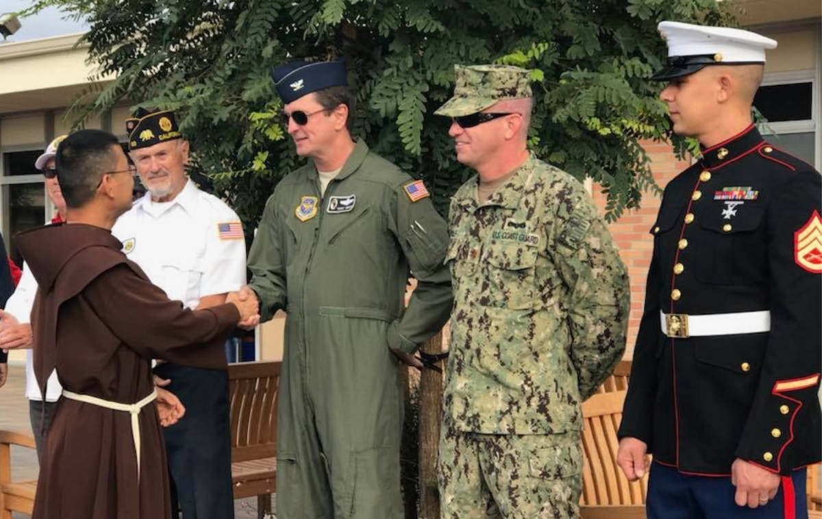 Br. Vincent Nguyen, OFM, greets military personnel on Veterans Day.  (Photo courtesy of Br. Vincent Nguyen, OFM)