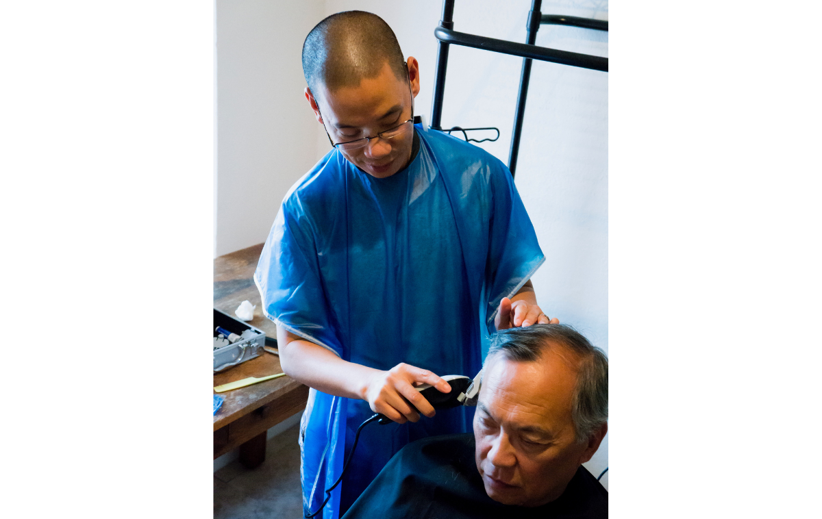 Br. Vincent Nguyen, OFM, is a man of many talents. Here, he gives Br. Franklin Fong, OFM, a fresh haircut. (Photo courtesy of Br. Vincent Nguyen, OFM)