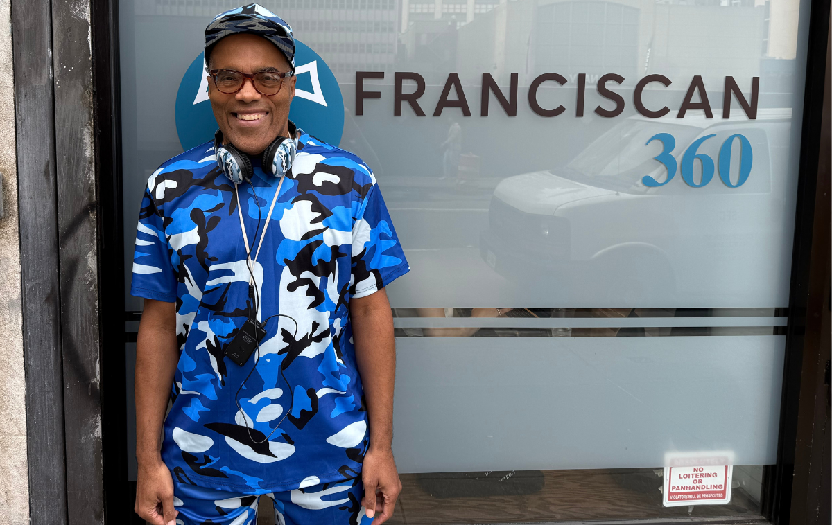 Something to smile about! Guest John C. posing near Franciscan 360’s welcoming doorway. (Photo courtesy of Franciscan 360)