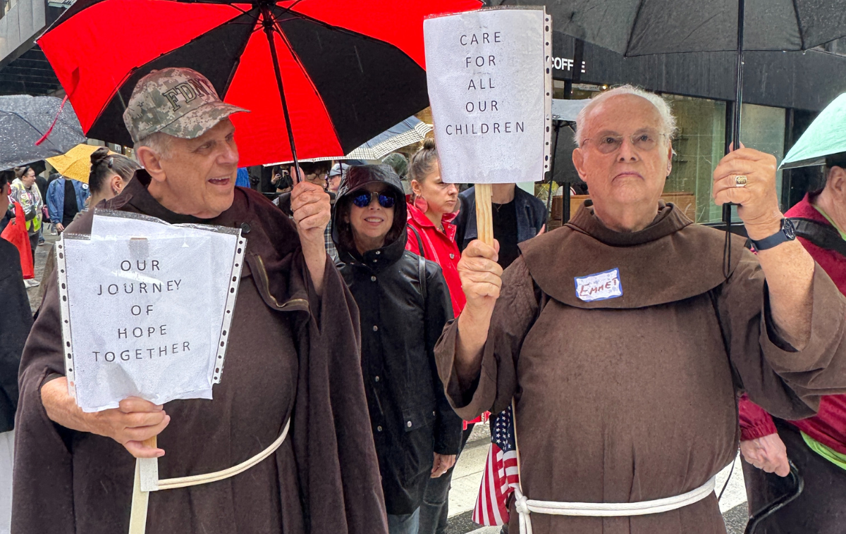 Br. Christopher Keenan, OFM, age 82, on left, and Br. Emmet Murphy, OFM, 91, on right, provided a ministry of presence to marchers in New York City. (Photo courtesy of Ann Kansfield) (Photo courtesy of Br. Larry Ford, OFM)