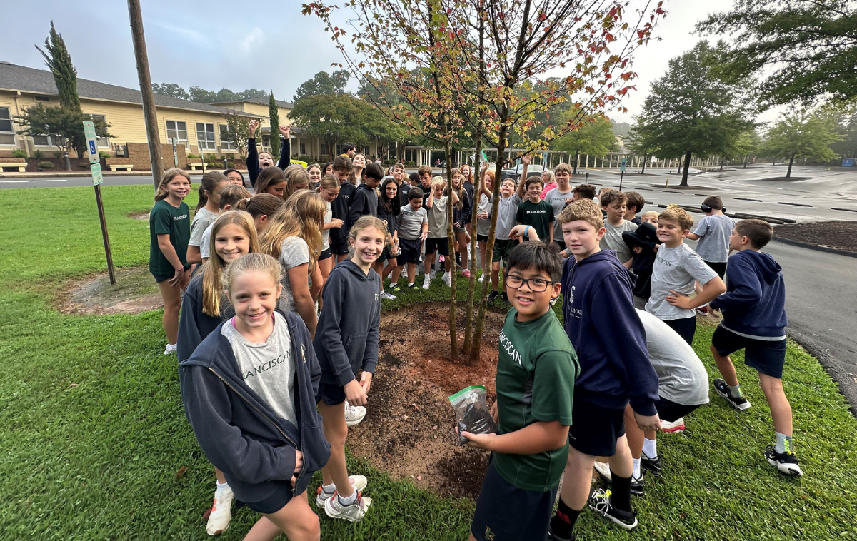5th grades spread dirt from their homes around the newly planted Trident Maple Tree, part of the 25th anniversary celebrations. (Photo courtesy of Laureen Wacenske)