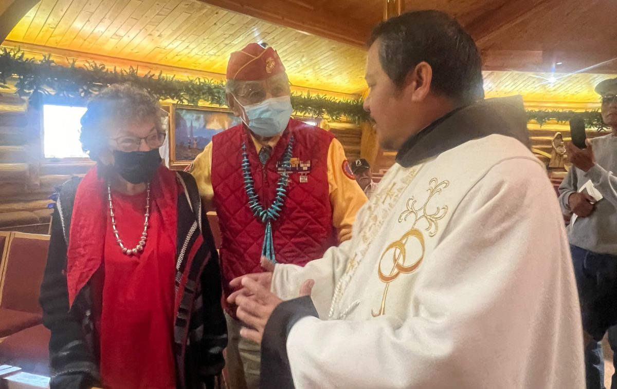 A friar greets parishioners after Mass.