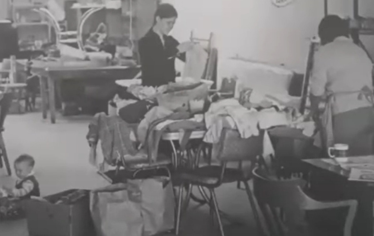 Volunteers sort clothing at the Anawim storefront near the Armitage Street apartments where Gospel Family members lived. The group provided a variety of goods for those in need, including food and clothing. Gospel Family originated with four Franciscan friars from the legacy Assumption Province, who settled into that apartment in October 1969. (Photo courtesy of Br. David Buer, OFM)