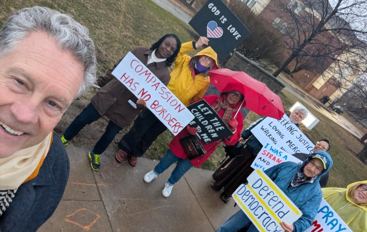 Br. Jeff Scheeler, OFM, (in the front, left) prays for respect of human dignity outside of an ICE regional office with the Interfaith Association of Southfield. Participants included a rabbi and an Episcopal priest. (Photo courtesy of Br. Jeff)