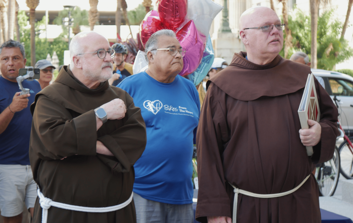 Brothers Zachary Elliott, OFM, and Michael Jones, OFM, attend the celebration marking the 3,000th bike donated by Bikes from the Heart. "Taking discarded or unused bicycles and breathing new life into them honors Franciscan care for creation by reusing resources to serve those on the margins," Br. Mike said. (Photo courtesy of Sacred Heart Parish)