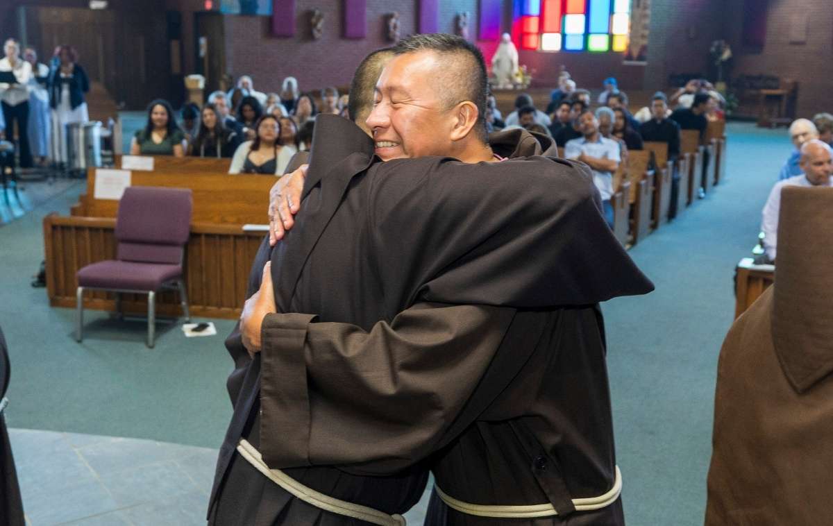 The more than 100 friars in attendance greeted each of their newly professed brothers with the sign of peace. Here, Provincial Councilor Br. Rommel Perez, OFM, shares the sign of peace with Br. JP. (Photo courtesy of Br. Octavio Duran, OFM)
