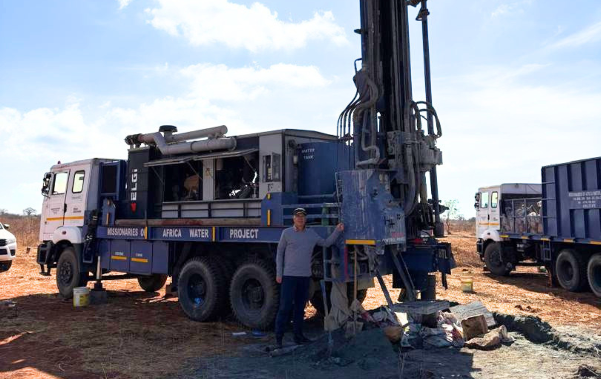 Br. Francis Kim, OFM, is shown in Tanzania earlier this year in front of a truck that digs deep holes into the ground for drilling water wells. (Photo from Br. Francis)&nbsp;