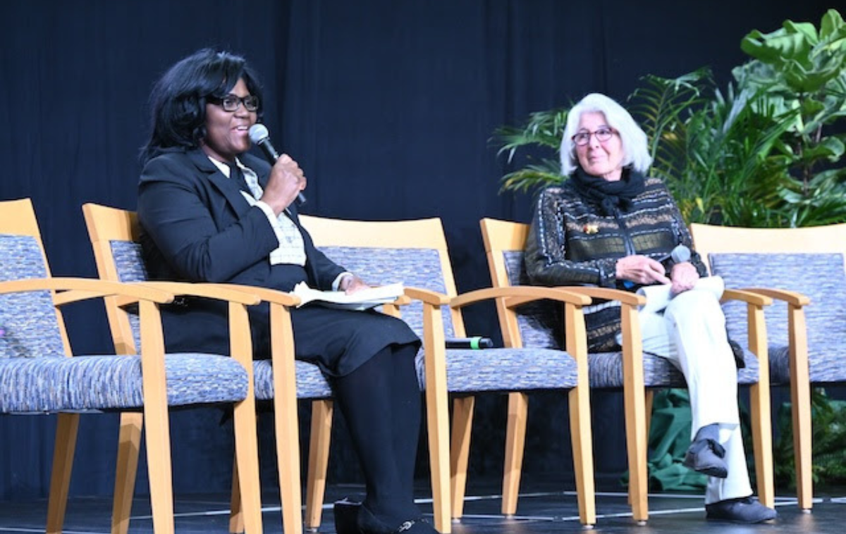 Amy Domini, of Domini Impact Investments Fund, right, looks on as Andrea Smith-Hunter, Ph.D., professor of management at Siena, introduces the panel discussion on the importance of a fair, just and equitable economy. (Photo courtesy of Siena University)