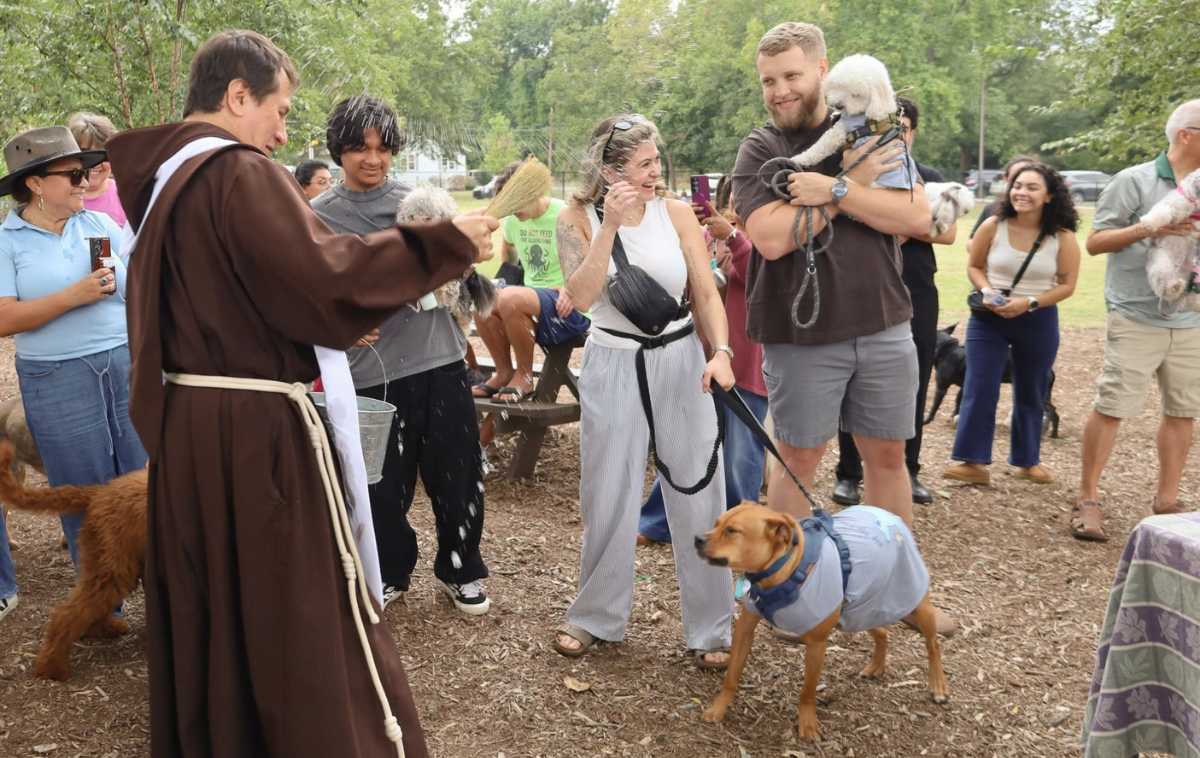 Br. Gonzalo de Jesús Torres-Acosta, OFM, blesses several dogs – and their two-legged companions. (Photo courtesy of Immaculate Conception Catholic Church)