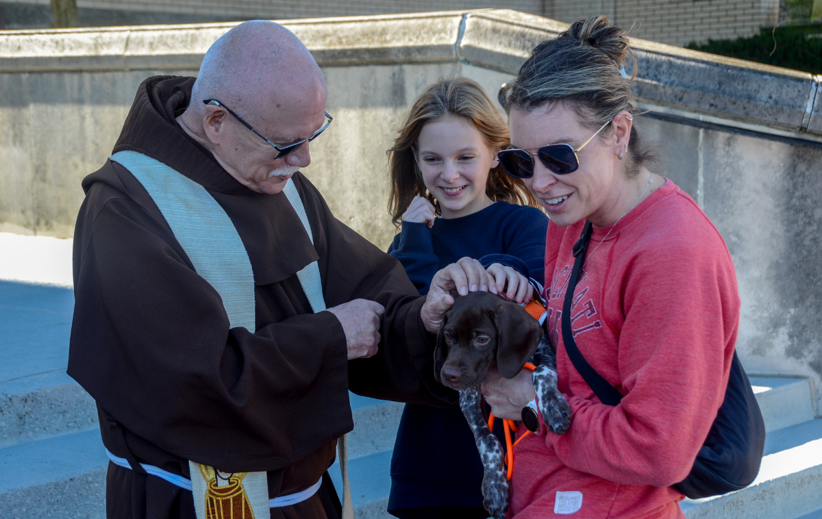 Just one of many sweet puppies who received a special blessing in Cincinnati – this one from Br. Manuel Viera, OFM. (Photo by Br. Frank Jasper, OFM)
