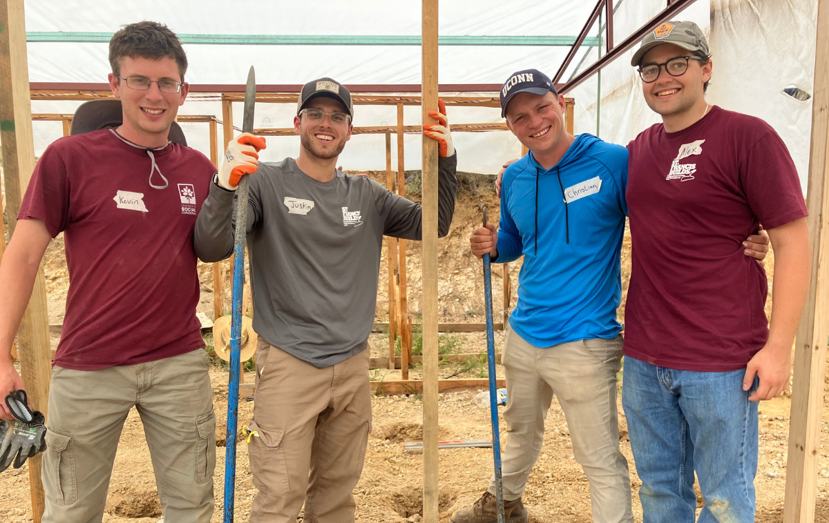 From left to right: Br. Kevin Fox OFM, Justin Tomaino (St. Patrick-St. Anthony parishioner), Christian Heiden, and Alex Almagro (St. Patrick-St. Anthony parishioner) work together to build a hydroponics farm. (photo courtesy of Levo International)