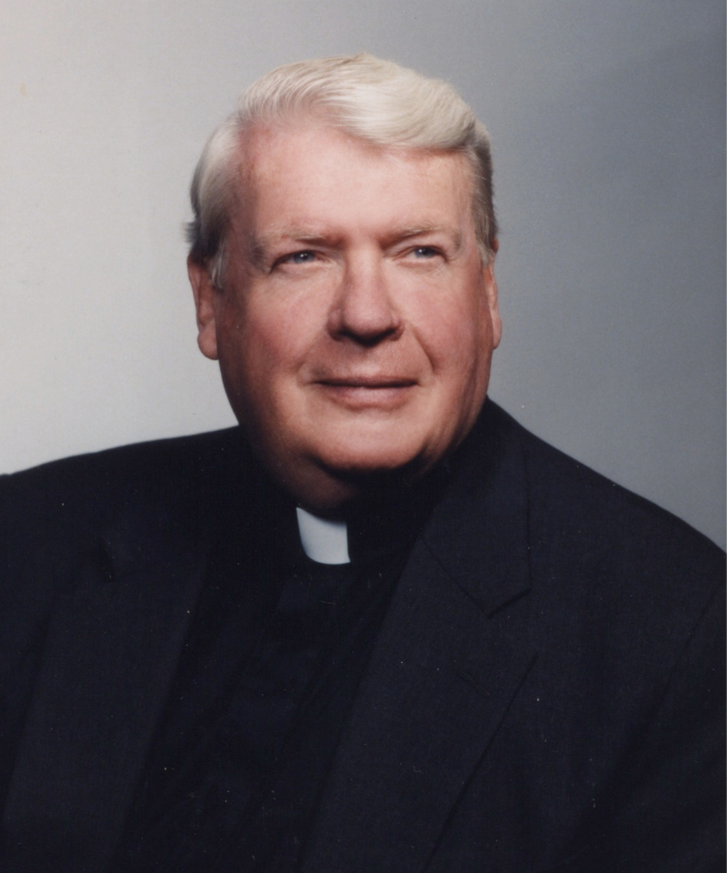 A man wearing a clergy collar.